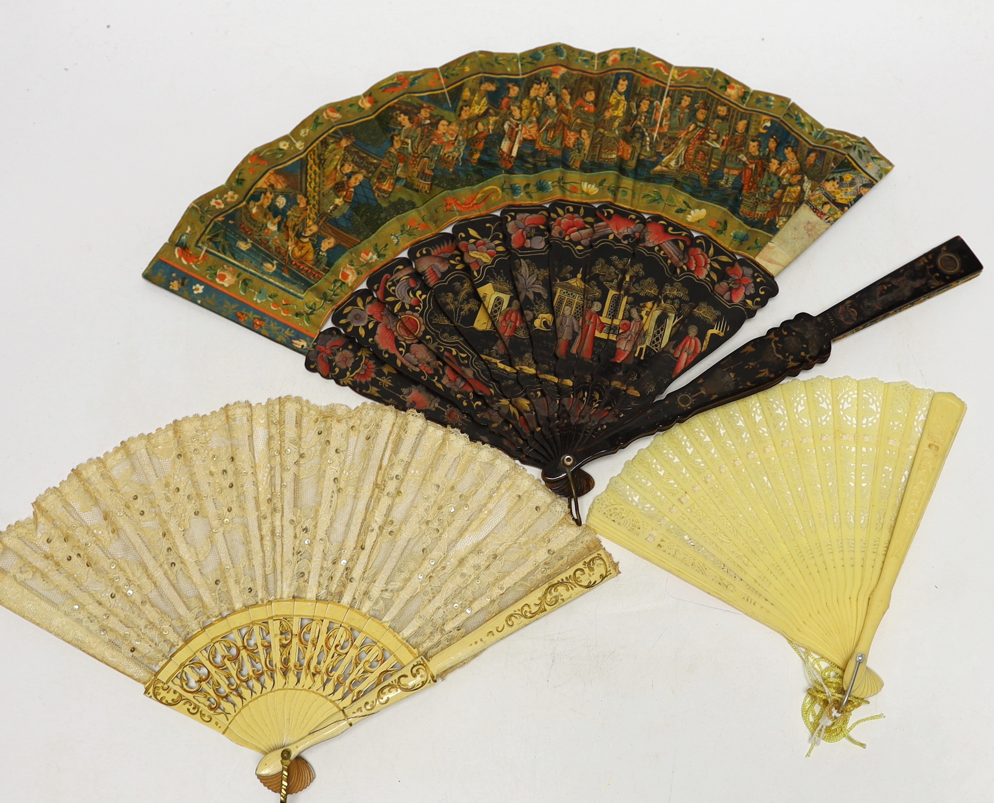 An early 20th century Chinese painted and lacquer fan, together with two others